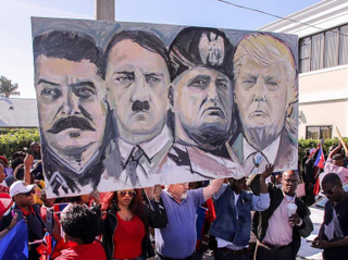 Haitian community members gather at the Southern Boulevard bridge in West Palm Beach, Fla., on Monday to protest reports of President Donald Trump’s recent vulgar remarks against Haiti. (Damon Higgins/Palm Beach Post)